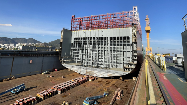 Ship components, heavy machinery, and construction equipment at the Hanwha Ocean Shipyard in Okpo, South Korea, during preparations for the keel laying of the Hamburg Express